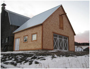 This new, cedar-sided barn in Quebec will weather to a dark gray and match the old the farm barn behind it. It was built from inexpensive, stock pole-barn plans by architect Don Berg at BarnsBarnsBarns.com